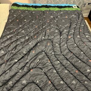 Rumpl Hippietree collaboration rainproof blanket with mountain and tree pattern